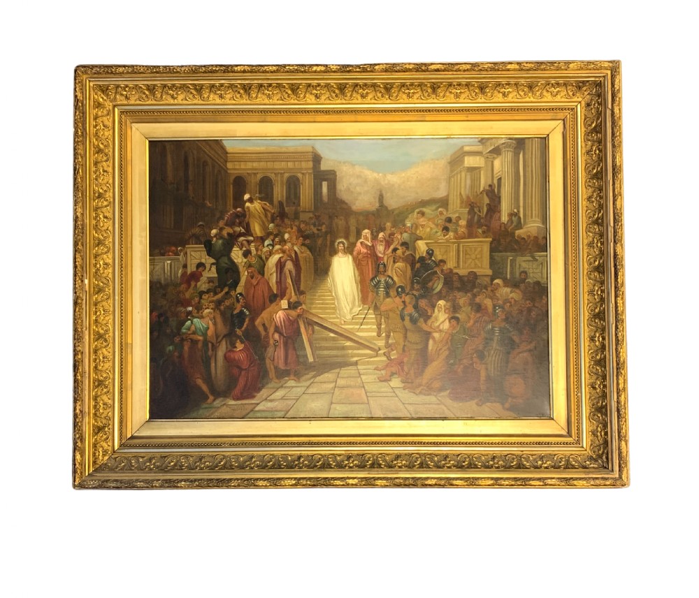 A large framed oil painting depicting a biblical narrative scene with Christ carrying the cross amidst a crowd, presented in an ornate giltwood frame.
