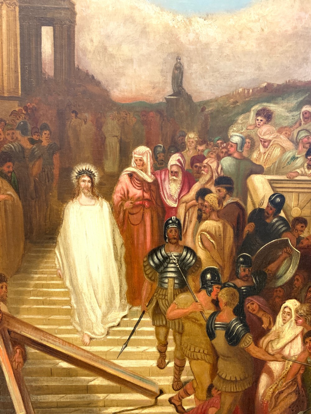 A large framed oil painting depicting a biblical narrative scene with Christ carrying the cross amidst a crowd, presented in an ornate giltwood frame. View VII