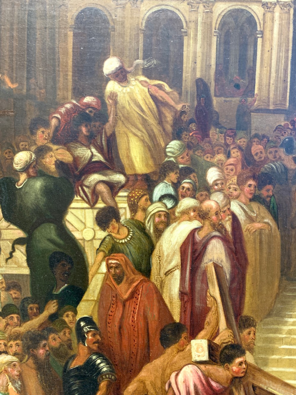 A large framed oil painting depicting a biblical narrative scene with Christ carrying the cross amidst a crowd, presented in an ornate giltwood frame. View IX