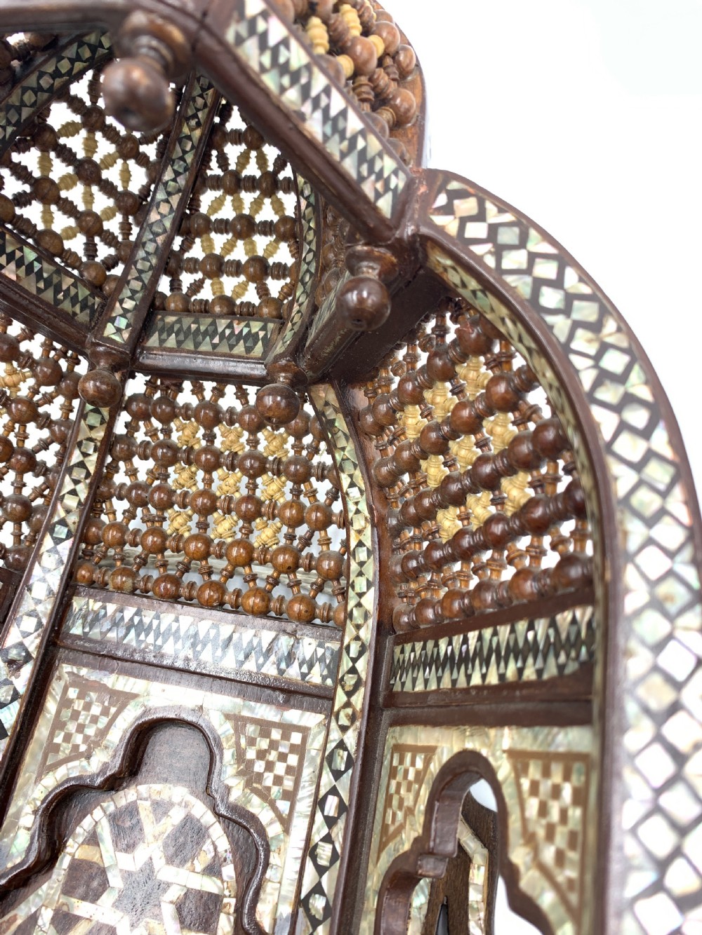 An intricately carved 19th-century Syrian walnut wall bracket featuring architectural arches, a domed canopy, and dense geometric mother-of-pearl inlay. View III