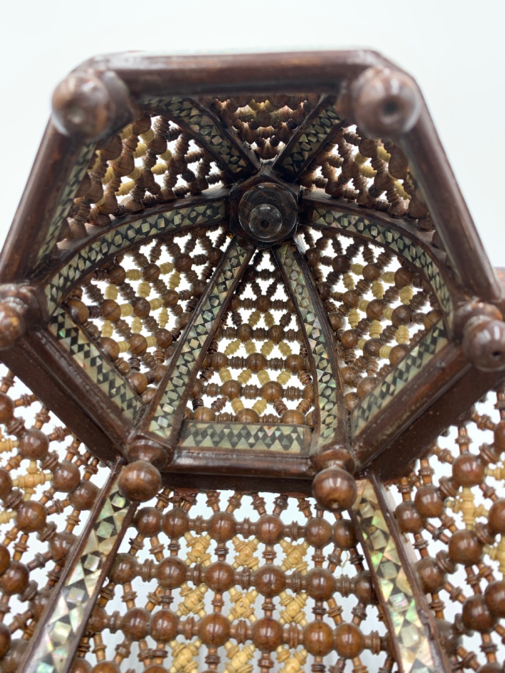 An intricately carved 19th-century Syrian walnut wall bracket featuring architectural arches, a domed canopy, and dense geometric mother-of-pearl inlay. View IV