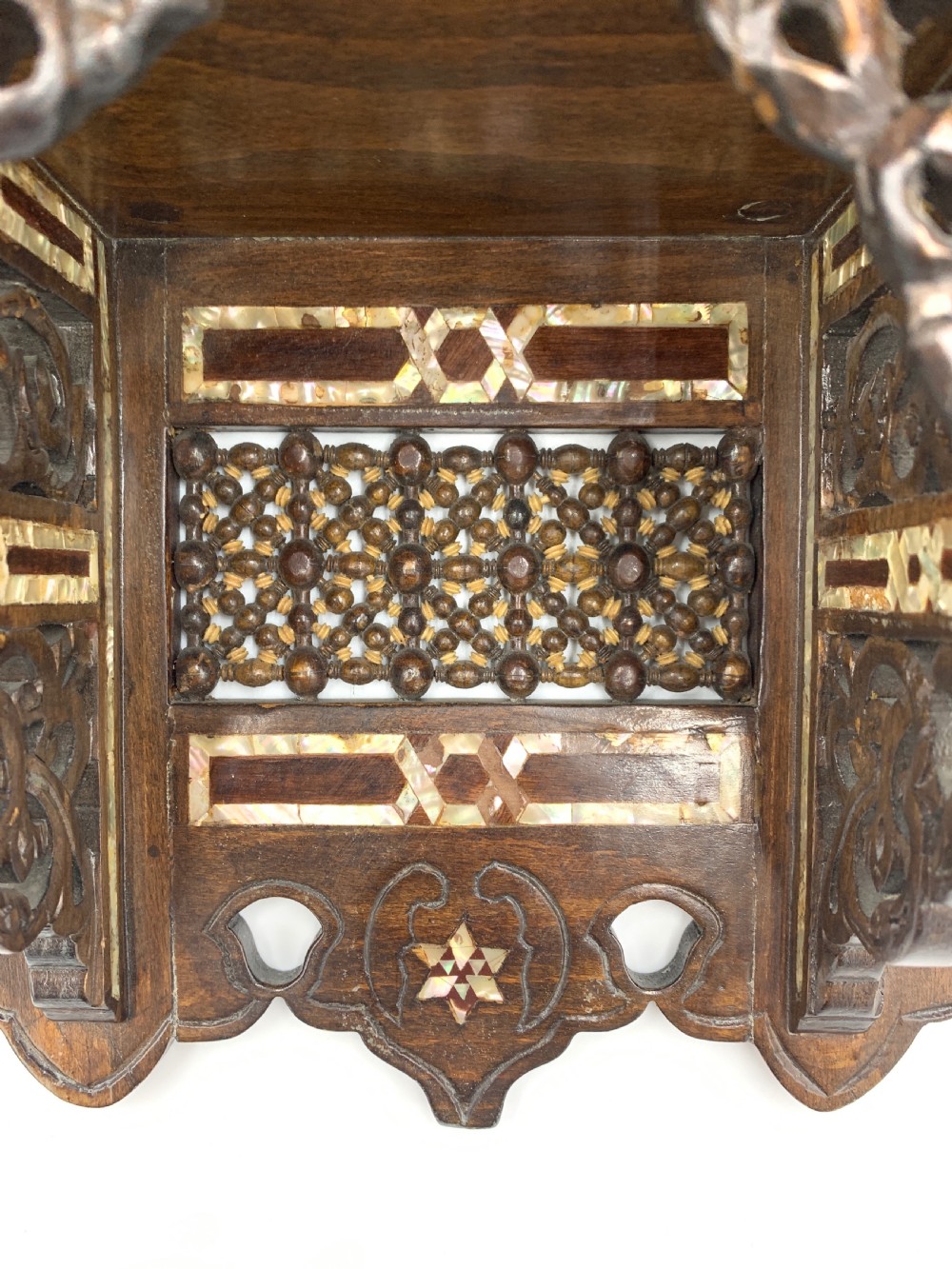 An intricately carved 19th-century Syrian walnut wall bracket featuring architectural arches, a domed canopy, and dense geometric mother-of-pearl inlay. View VI