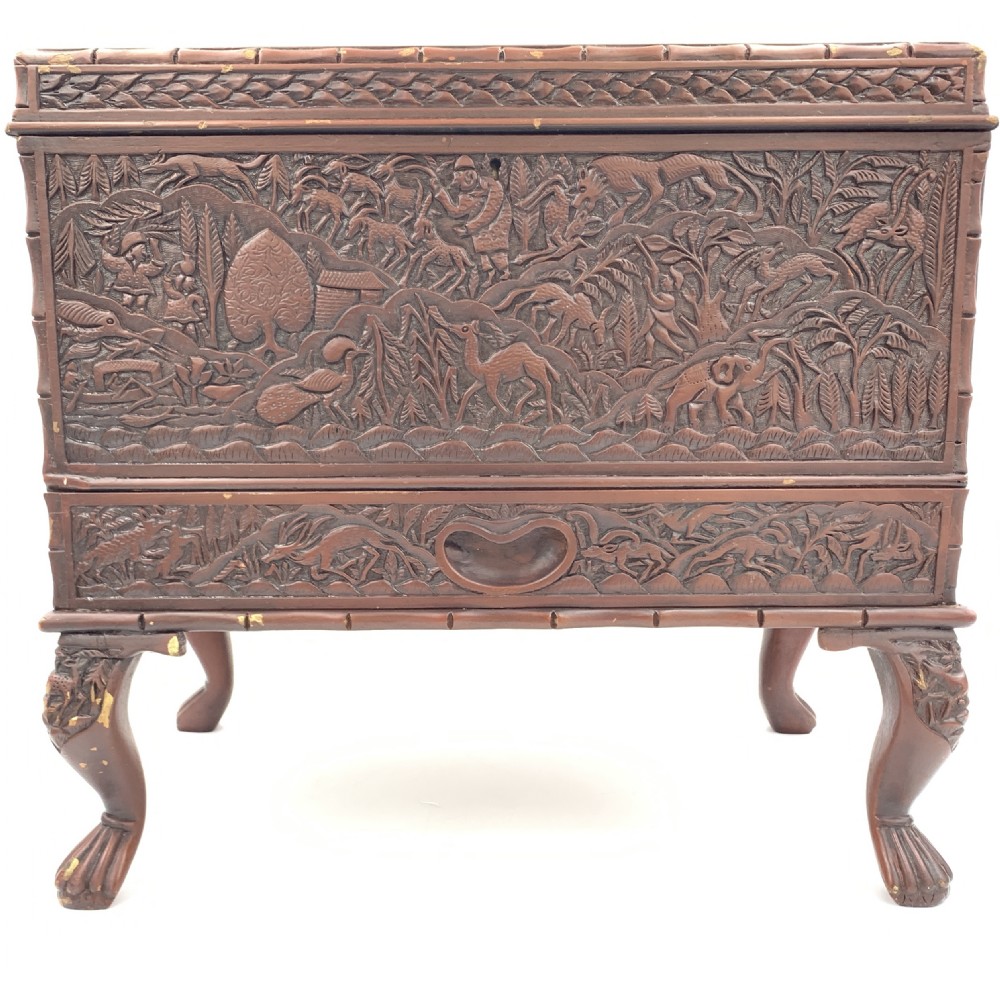 A 19th-century South Indian carved sandalwood jewellery box decorated with high-relief animal and floral motifs, supported by four carved legs. View II