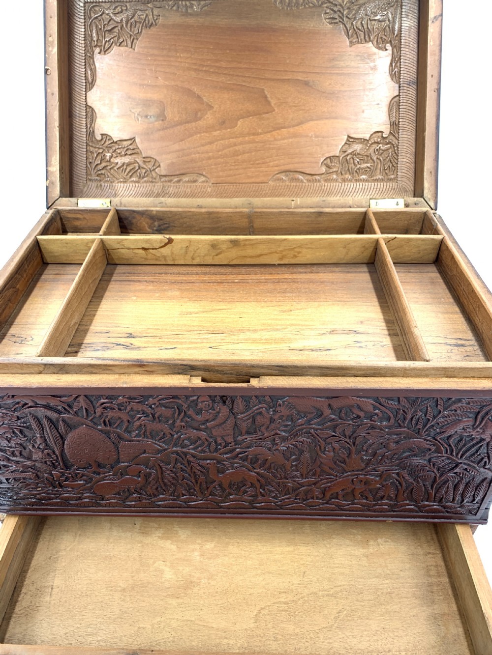 A 19th-century South Indian carved sandalwood jewellery box decorated with high-relief animal and floral motifs, supported by four carved legs. View VIII