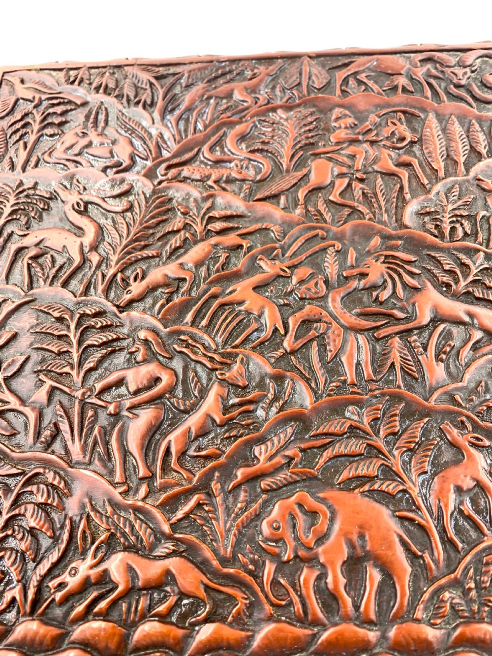 A 19th-century South Indian carved sandalwood jewellery box decorated with high-relief animal and floral motifs, supported by four carved legs. View X