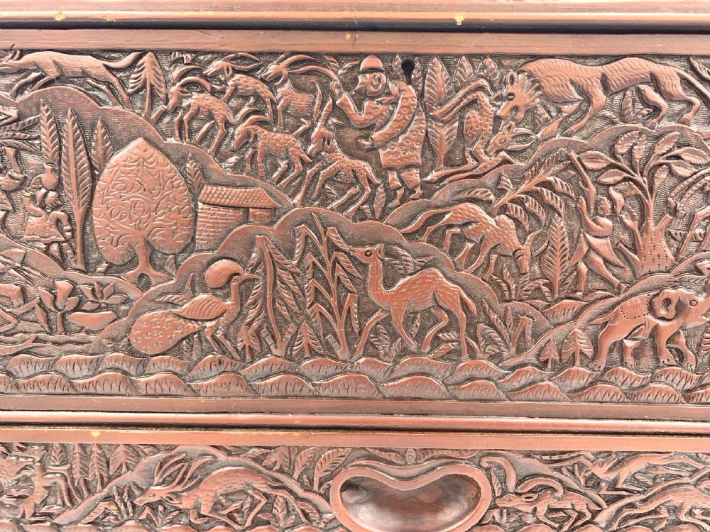 A 19th-century South Indian carved sandalwood jewellery box decorated with high-relief animal and floral motifs, supported by four carved legs. View XI