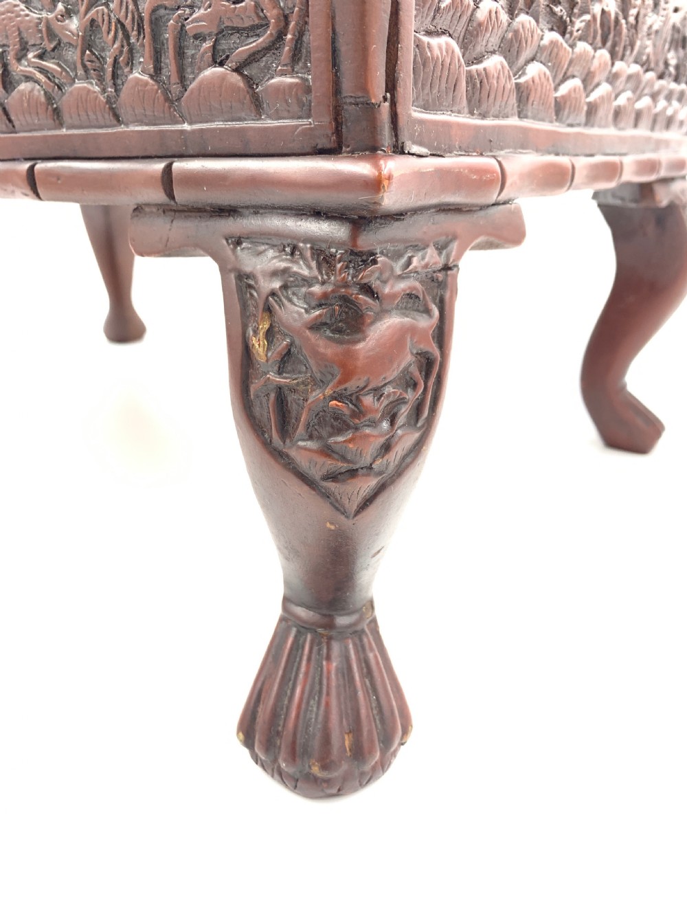 A 19th-century South Indian carved sandalwood jewellery box decorated with high-relief animal and floral motifs, supported by four carved legs. View XII