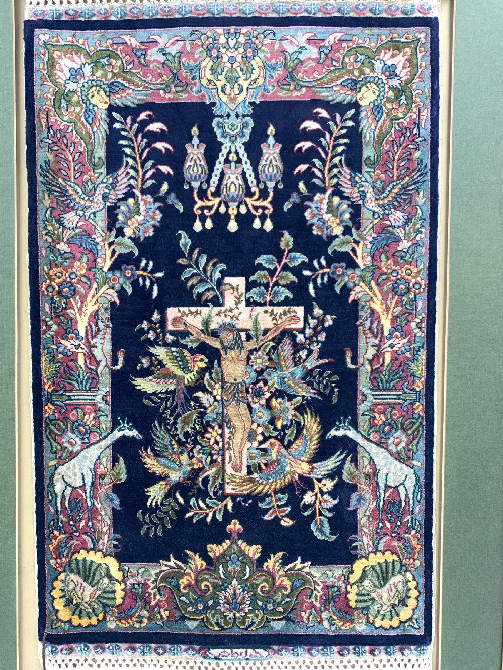 A framed Turkish miniature pure silk Hereke carpet featuring a central crucifix scene surrounded by bird motifs and floral borders. View II
