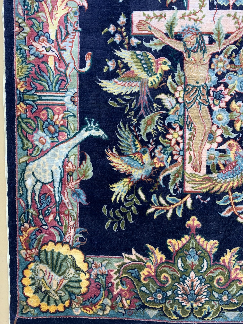 A framed Turkish miniature pure silk Hereke carpet featuring a central crucifix scene surrounded by bird motifs and floral borders. View III