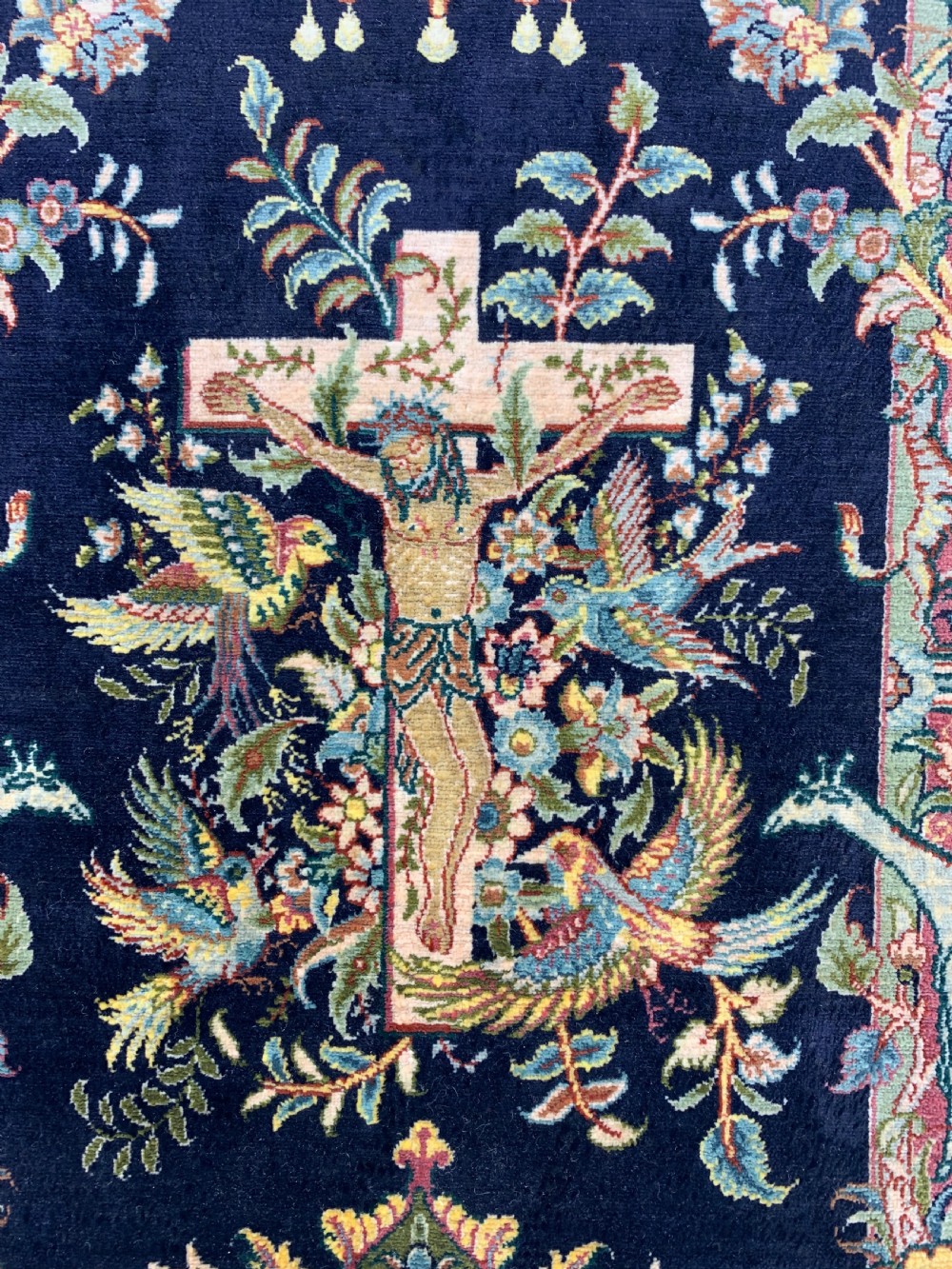 A framed Turkish miniature pure silk Hereke carpet featuring a central crucifix scene surrounded by bird motifs and floral borders. View IV