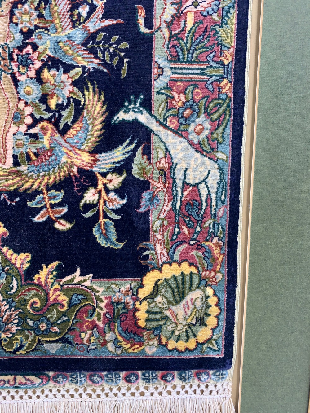 A framed Turkish miniature pure silk Hereke carpet featuring a central crucifix scene surrounded by bird motifs and floral borders. View V