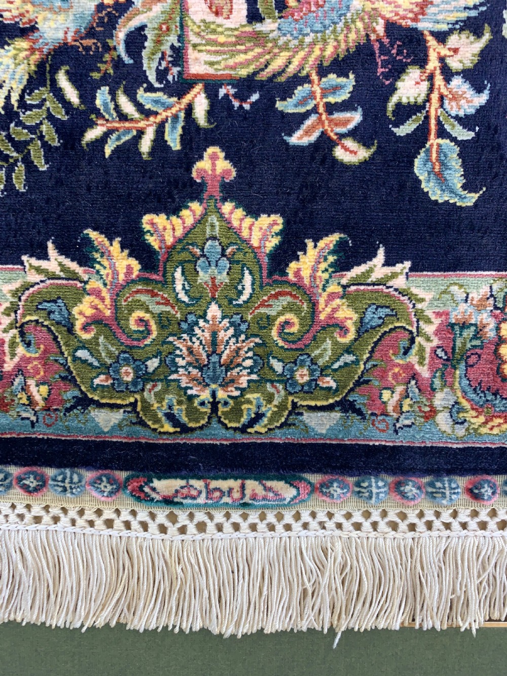 A framed Turkish miniature pure silk Hereke carpet featuring a central crucifix scene surrounded by bird motifs and floral borders. View VI