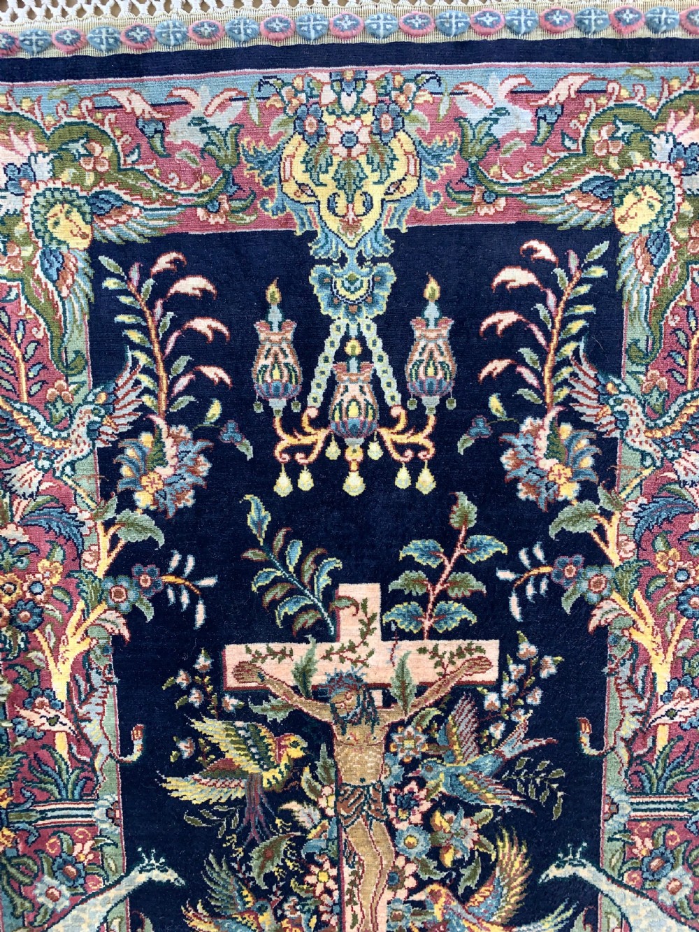 A framed Turkish miniature pure silk Hereke carpet featuring a central crucifix scene surrounded by bird motifs and floral borders. View VII