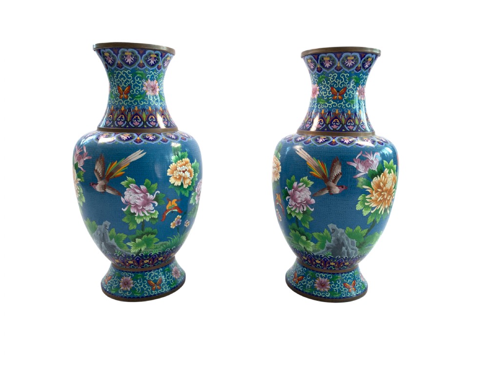 A pair of turquoise Chinese cloisonne enamel vases displaying floral motifs, resting on tall carved gilt stands. View II