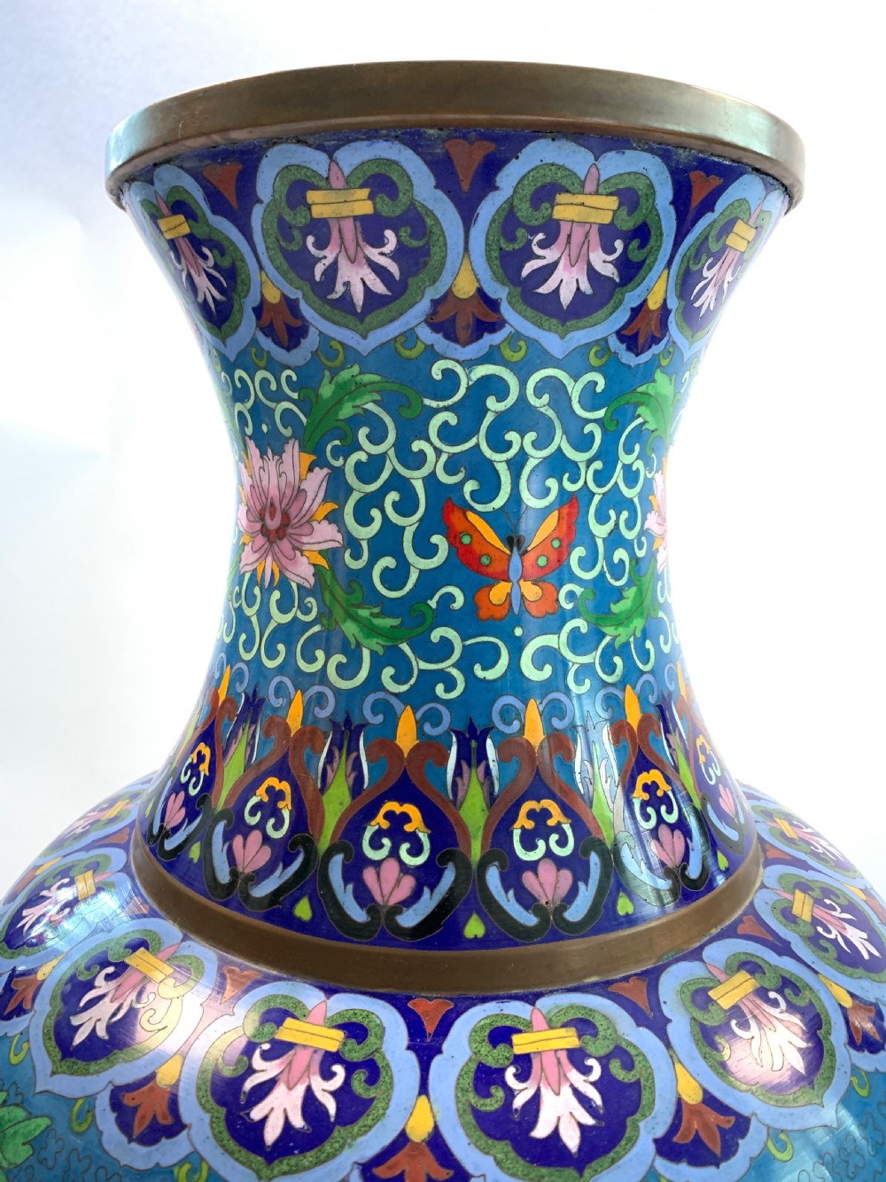 A pair of turquoise Chinese cloisonne enamel vases displaying floral motifs, resting on tall carved gilt stands. View III