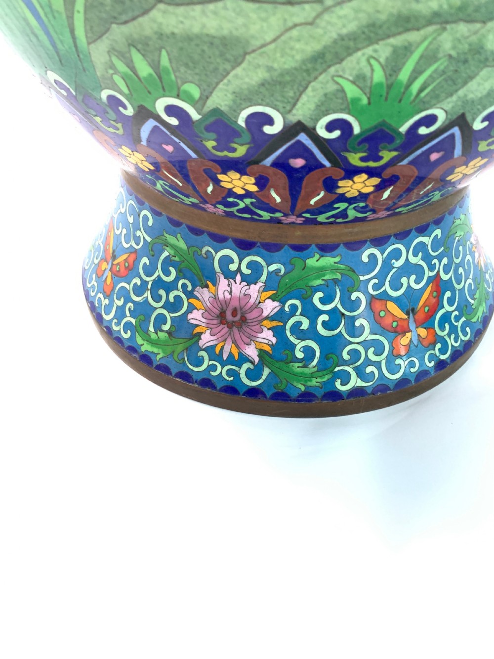 A pair of turquoise Chinese cloisonne enamel vases displaying floral motifs, resting on tall carved gilt stands. View IV