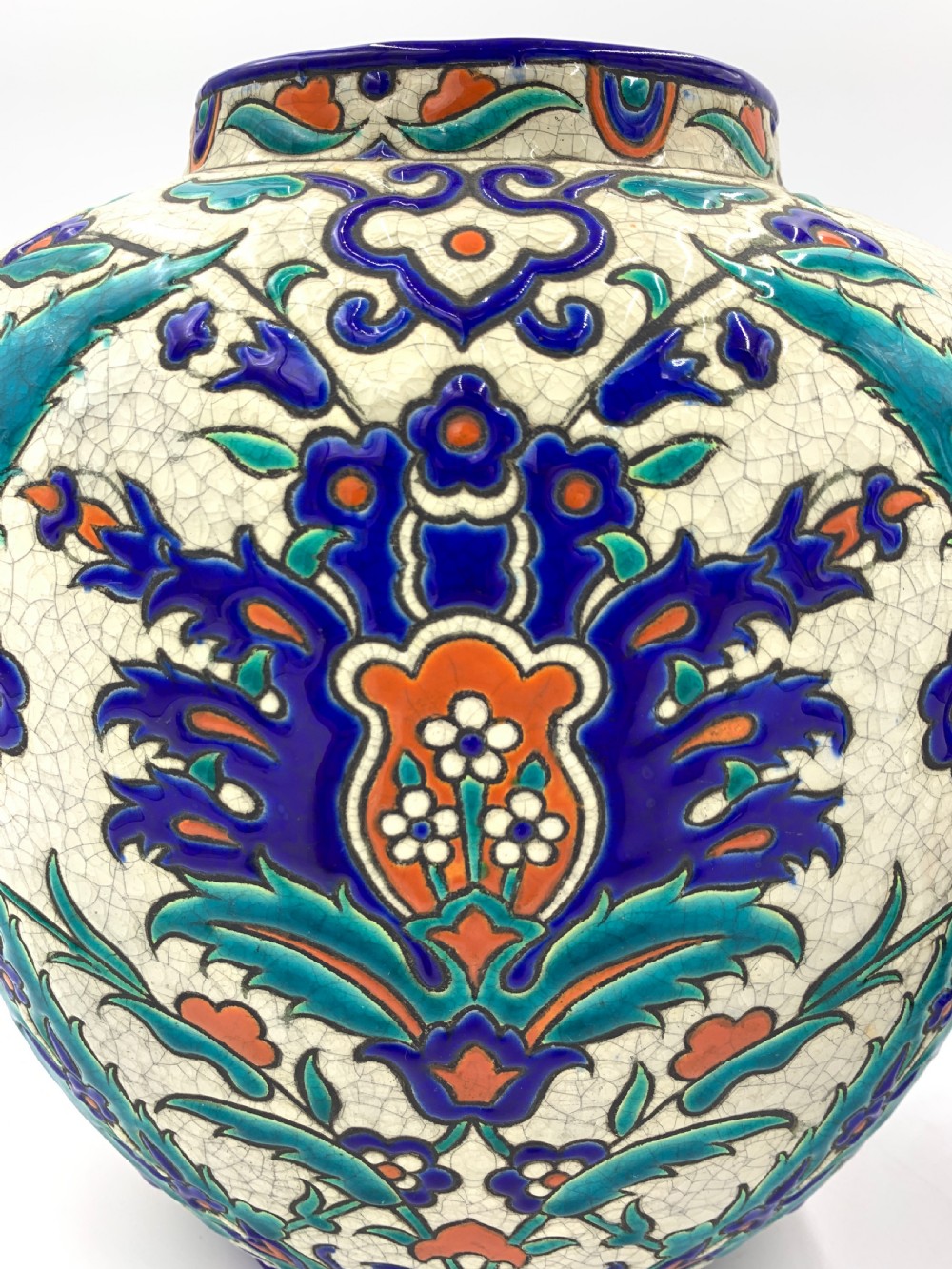 A pair of round ceramic vases decorated with Iznik-style blue, turquoise, and orange floral motifs over a crackled white glaze. View IV