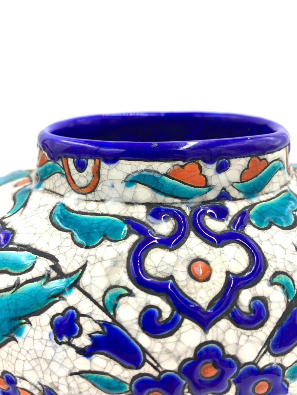 A pair of round ceramic vases decorated with Iznik-style blue, turquoise, and orange floral motifs over a crackled white glaze. View V