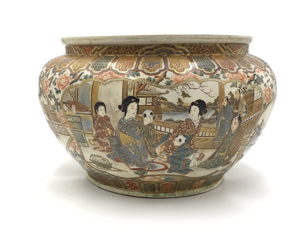 A large bulbous Japanese Satsuma earthenware bowl featuring intricate polychrome enamel scenes of figures in traditional attire, bordered by elaborate gilt geometric patterns on a crackled cream ground. View II