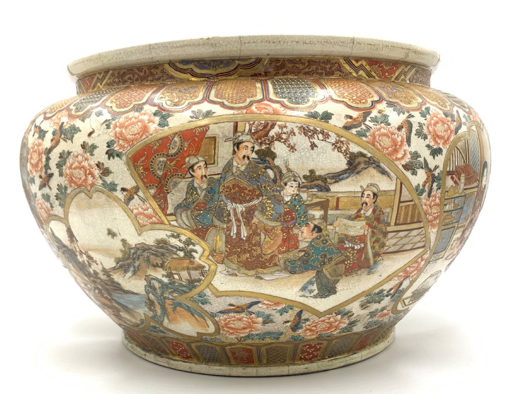 A large bulbous Japanese Satsuma earthenware bowl featuring intricate polychrome enamel scenes of figures in traditional attire, bordered by elaborate gilt geometric patterns on a crackled cream ground. View III