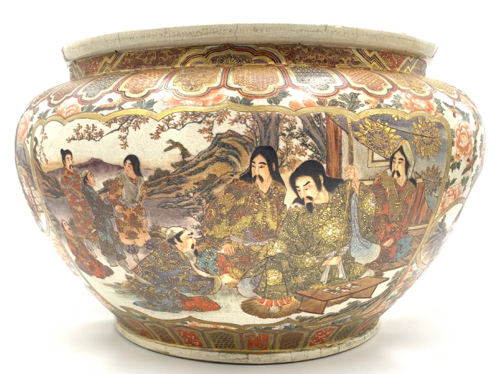 A large bulbous Japanese Satsuma earthenware bowl featuring intricate polychrome enamel scenes of figures in traditional attire, bordered by elaborate gilt geometric patterns on a crackled cream ground. View IV