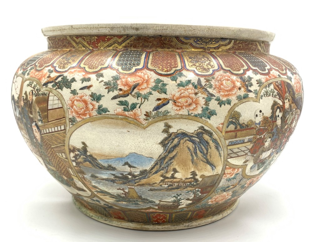 A large bulbous Japanese Satsuma earthenware bowl featuring intricate polychrome enamel scenes of figures in traditional attire, bordered by elaborate gilt geometric patterns on a crackled cream ground. View VI