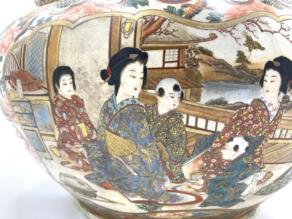 A large bulbous Japanese Satsuma earthenware bowl featuring intricate polychrome enamel scenes of figures in traditional attire, bordered by elaborate gilt geometric patterns on a crackled cream ground. View VII