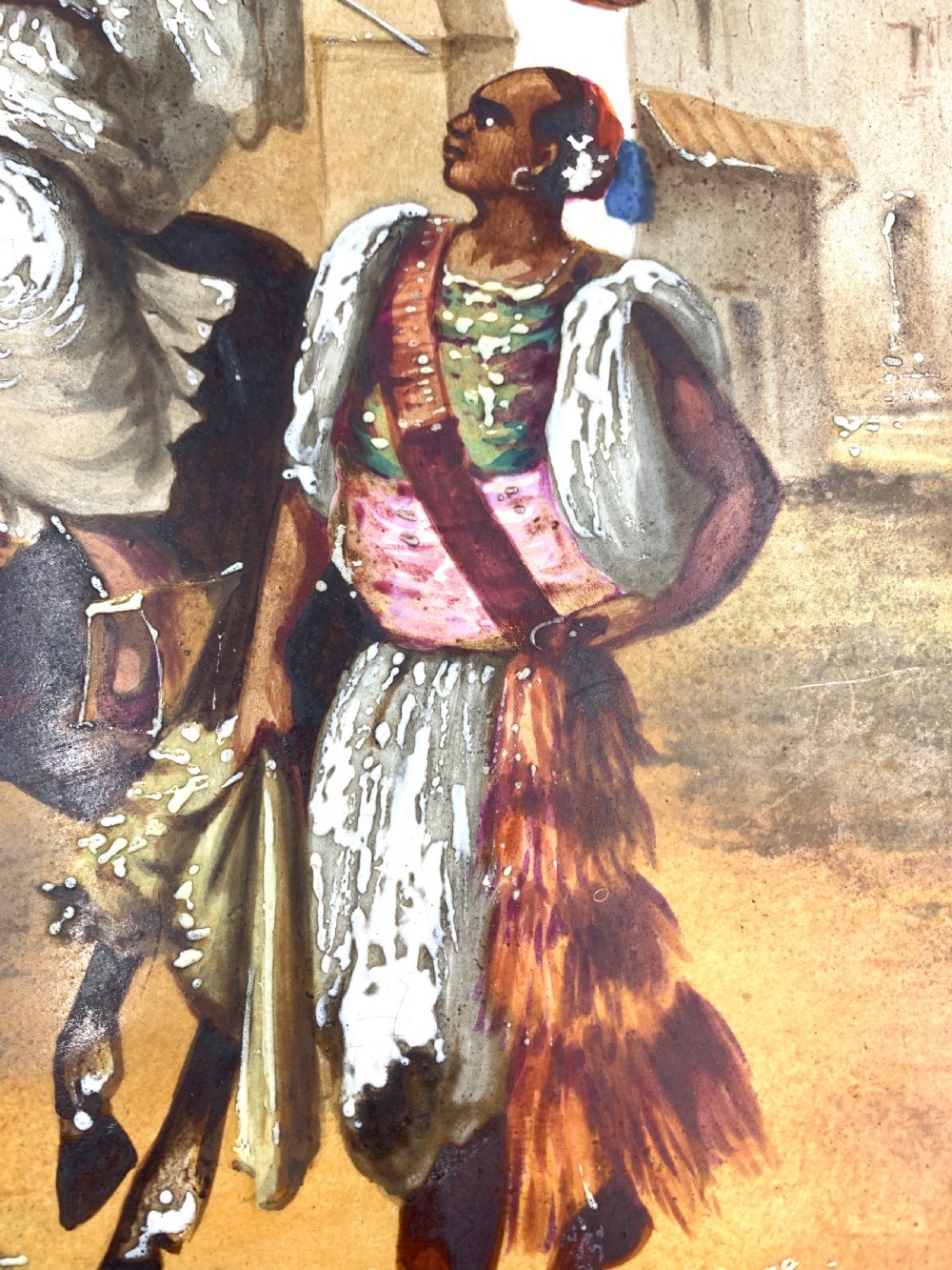 A circular 19th-century French porcelain plate decorated with a hand-painted Orientalist scene depicting an Arab horseman on a dark horse accompanied by a attendant in a sunny courtyard. View III