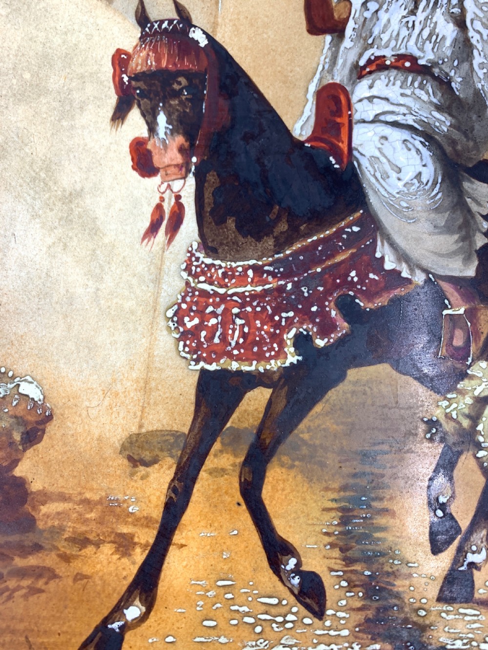 A circular 19th-century French porcelain plate decorated with a hand-painted Orientalist scene depicting an Arab horseman on a dark horse accompanied by a attendant in a sunny courtyard. View IV