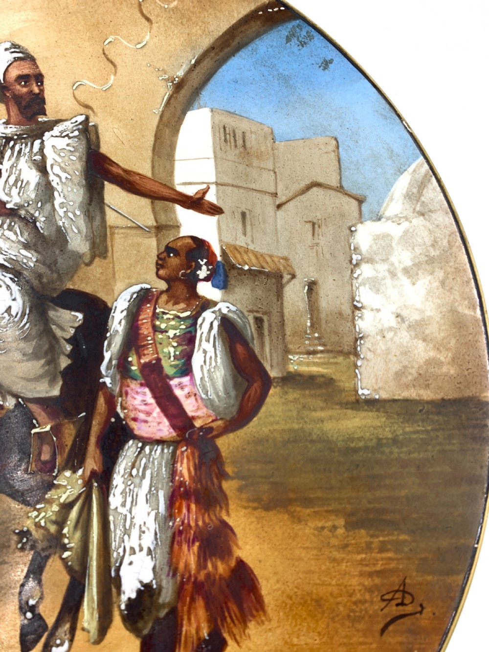 A circular 19th-century French porcelain plate decorated with a hand-painted Orientalist scene depicting an Arab horseman on a dark horse accompanied by a attendant in a sunny courtyard. View VII