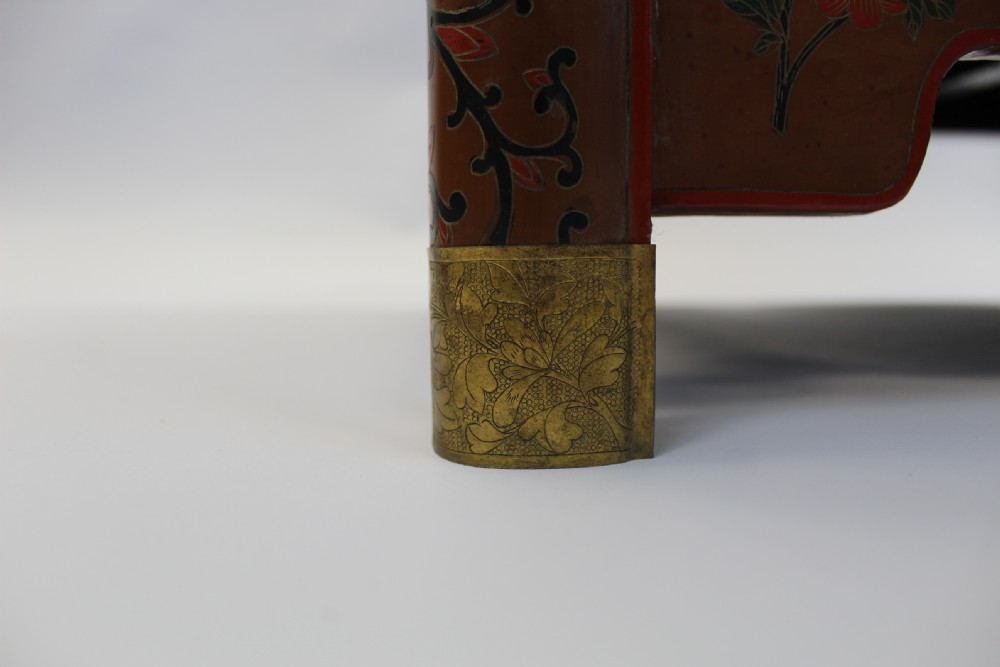 A 19th-century Chinese red lacquer cabinet featuring two doors decorated with carved white relief panels depicting figures, birds, and botanical motifs, fitted with brass lockplates. View XIV