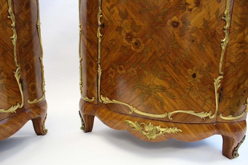A matching pair of 19th-century French corner cabinets featuring floral marquetry panels, curved doors, gilt bronze mounts, and red-brown marble tops. View II