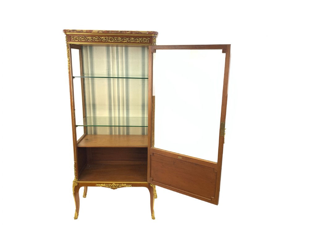 A 19th-century French Louis XVI style mahogany vitrine cabinet featuring glass side panels, gilt bronze mounts, a parquetry lower section, and a marble top. View III