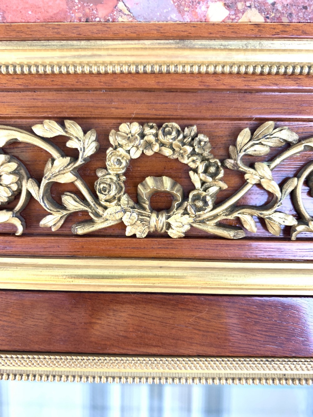 A 19th-century French Louis XVI style mahogany vitrine cabinet featuring glass side panels, gilt bronze mounts, a parquetry lower section, and a marble top. View V
