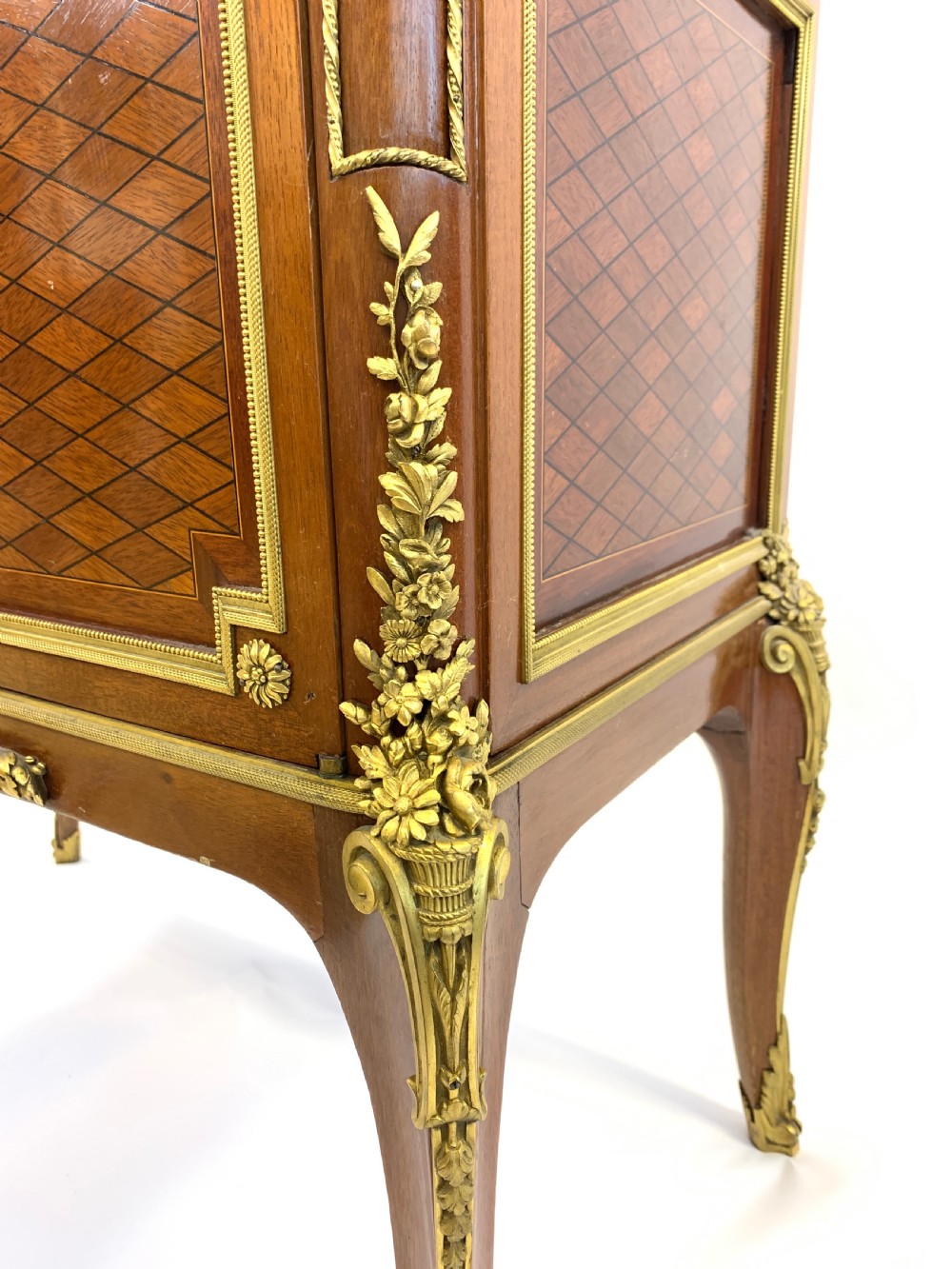 A 19th-century French Louis XVI style mahogany vitrine cabinet featuring glass side panels, gilt bronze mounts, a parquetry lower section, and a marble top. View VI
