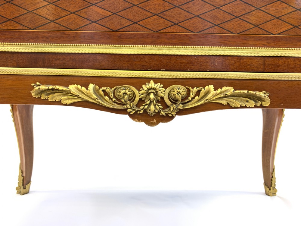A 19th-century French Louis XVI style mahogany vitrine cabinet featuring glass side panels, gilt bronze mounts, a parquetry lower section, and a marble top. View VIII