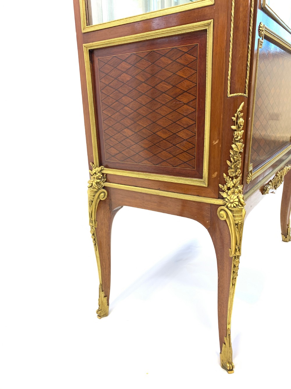 A 19th-century French Louis XVI style mahogany vitrine cabinet featuring glass side panels, gilt bronze mounts, a parquetry lower section, and a marble top. View IX
