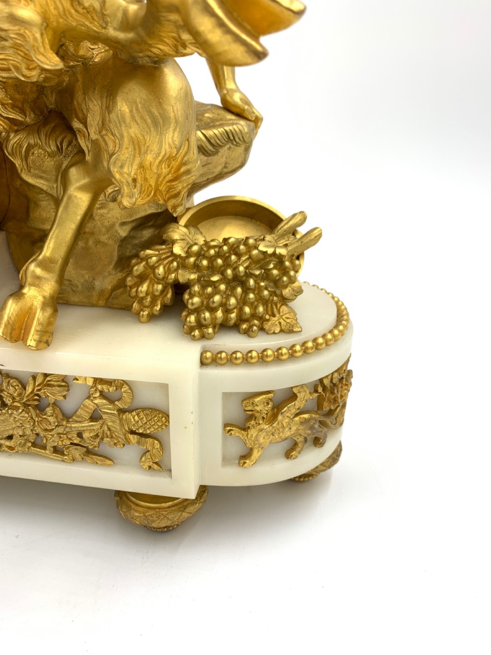 A late nineteenth-century French Louis XVI style gilt-bronze and white marble mantel clock featuring a sculptural bacchante figure alongside an enamel dial. View VI