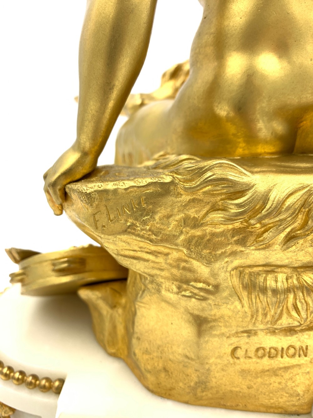 A late nineteenth-century French Louis XVI style gilt-bronze and white marble mantel clock featuring a sculptural bacchante figure alongside an enamel dial. View VII