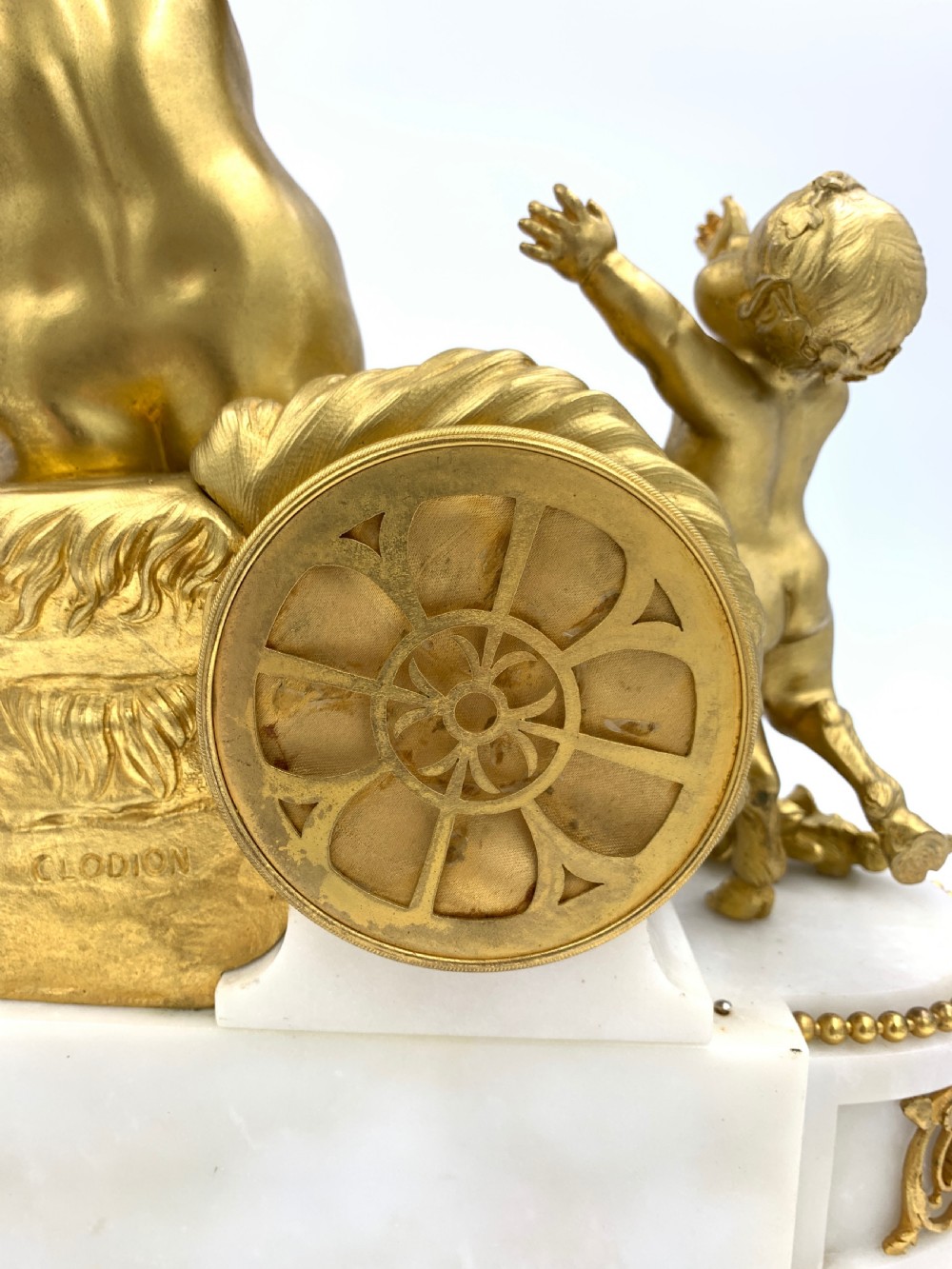 A late nineteenth-century French Louis XVI style gilt-bronze and white marble mantel clock featuring a sculptural bacchante figure alongside an enamel dial. View IX