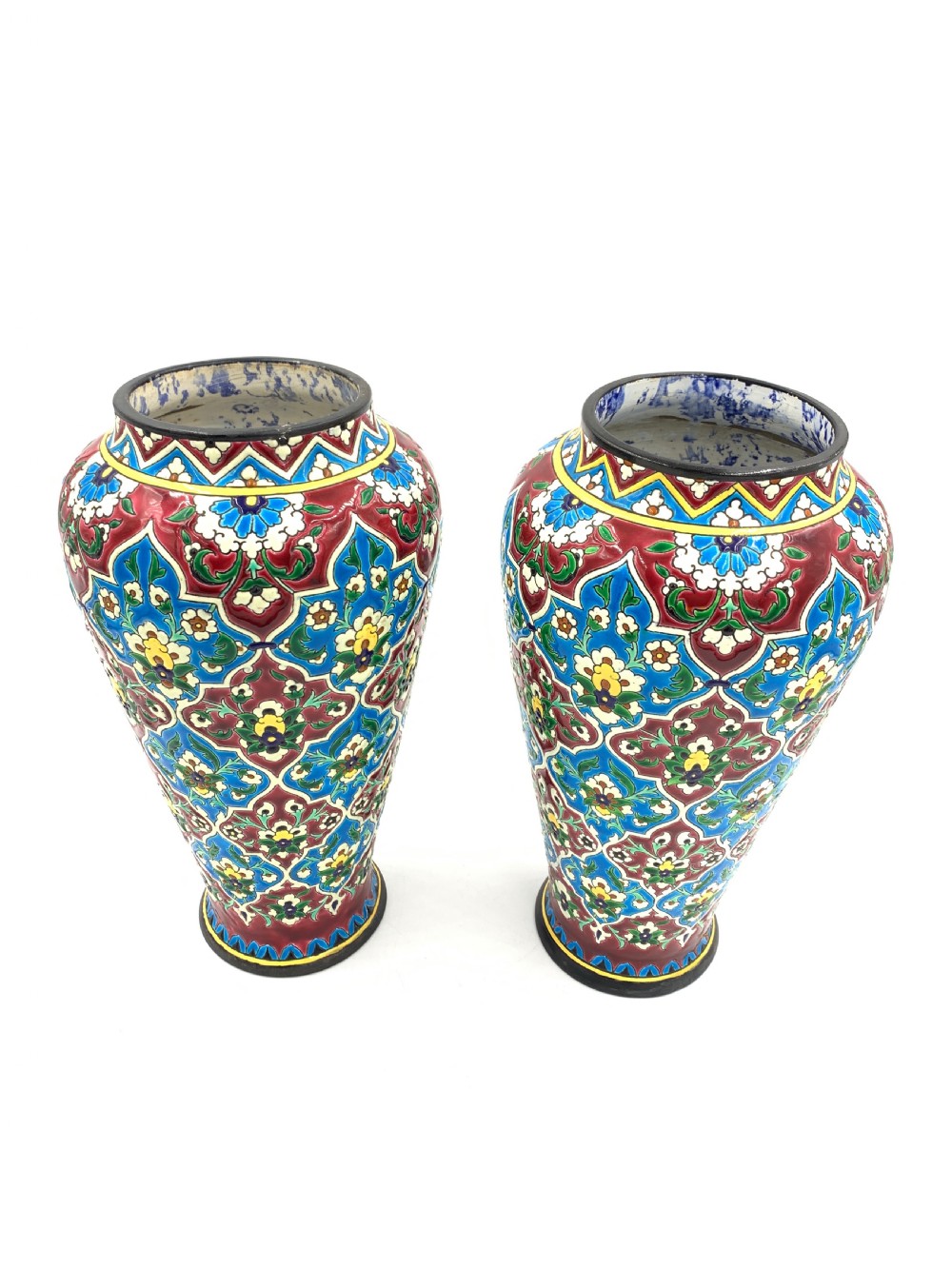 A pair of baluster-shaped French faience vases decorated with vibrant blue, crimson, and yellow enamelled floral arabesque patterns. View II