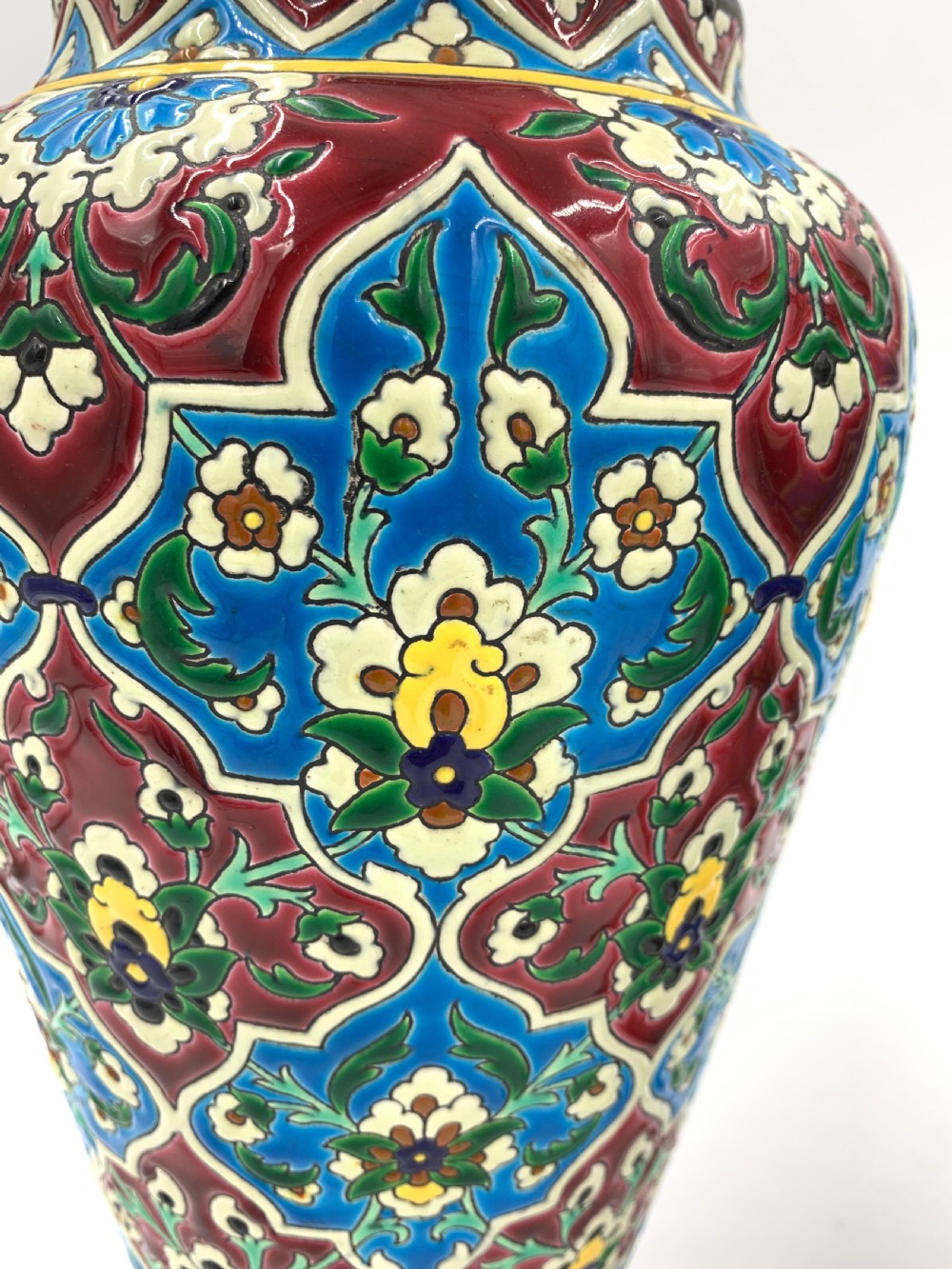 A pair of baluster-shaped French faience vases decorated with vibrant blue, crimson, and yellow enamelled floral arabesque patterns. View IV