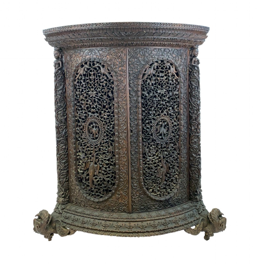 HEAVILY CARVED ANGLO INDIAN CORNER CABINET, 19TH CENTURY  