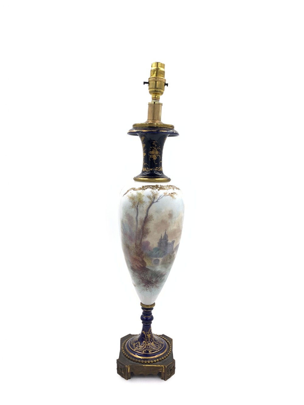 A 19th-century French Sevres style porcelain urn table lamp featuring hand-painted figures, cobalt blue accents, gilt detail, and a pleated silk shade. View IV