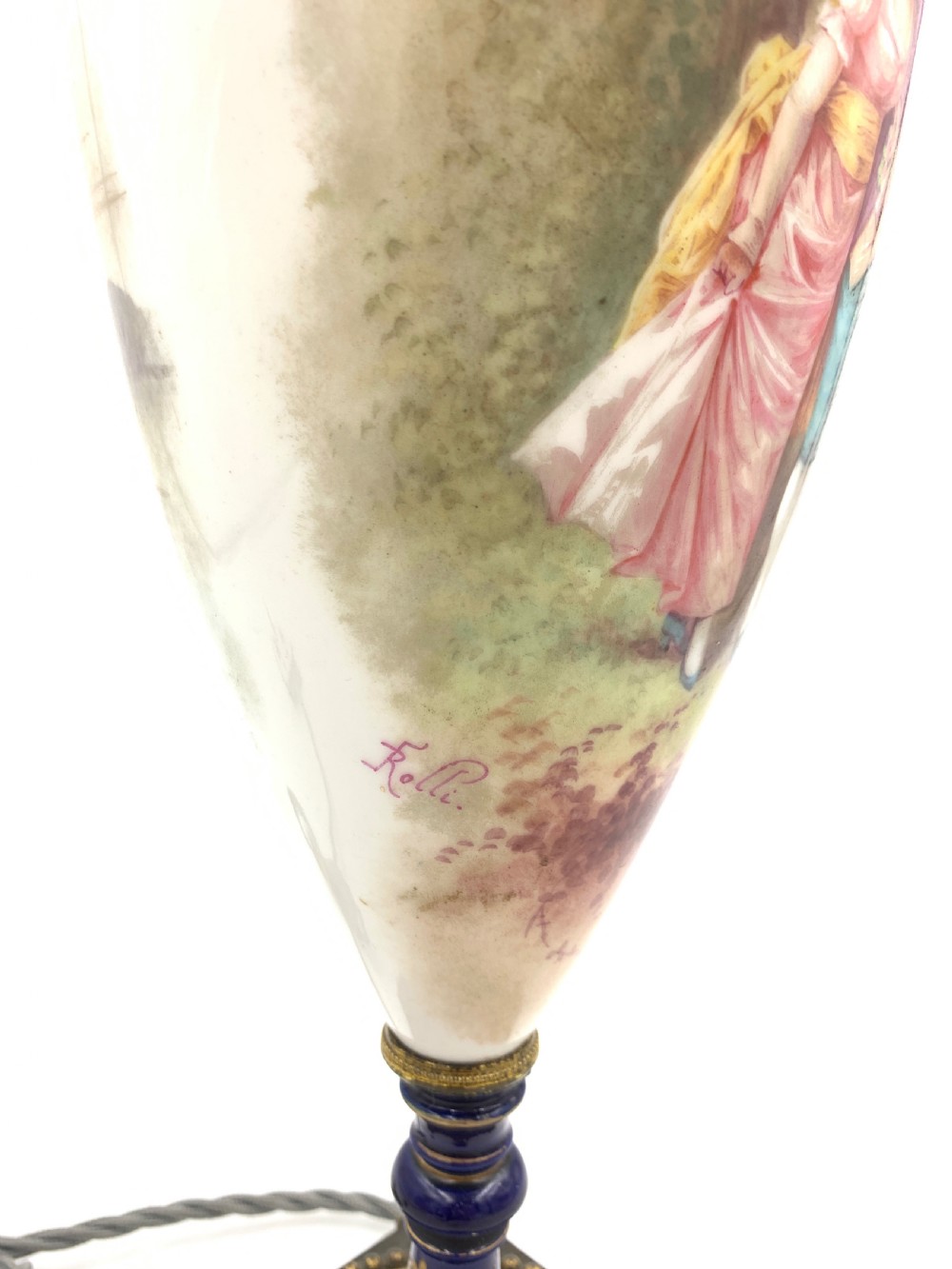 A 19th-century French Sevres style porcelain urn table lamp featuring hand-painted figures, cobalt blue accents, gilt detail, and a pleated silk shade. View VII
