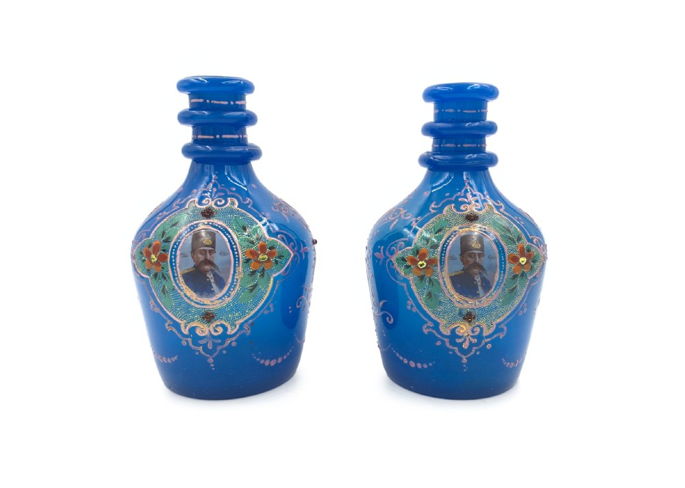 A PAIR OF ROYAL BLUE OPAQUE JEWELLED AND ENAMELLED BOHEMIAN GLASS HOOKAH BASES WITH PORTRAITS OF SULTAN MOZAFFAR AL-DIN SHAH QAJAR DATED 1315 HIJRI 