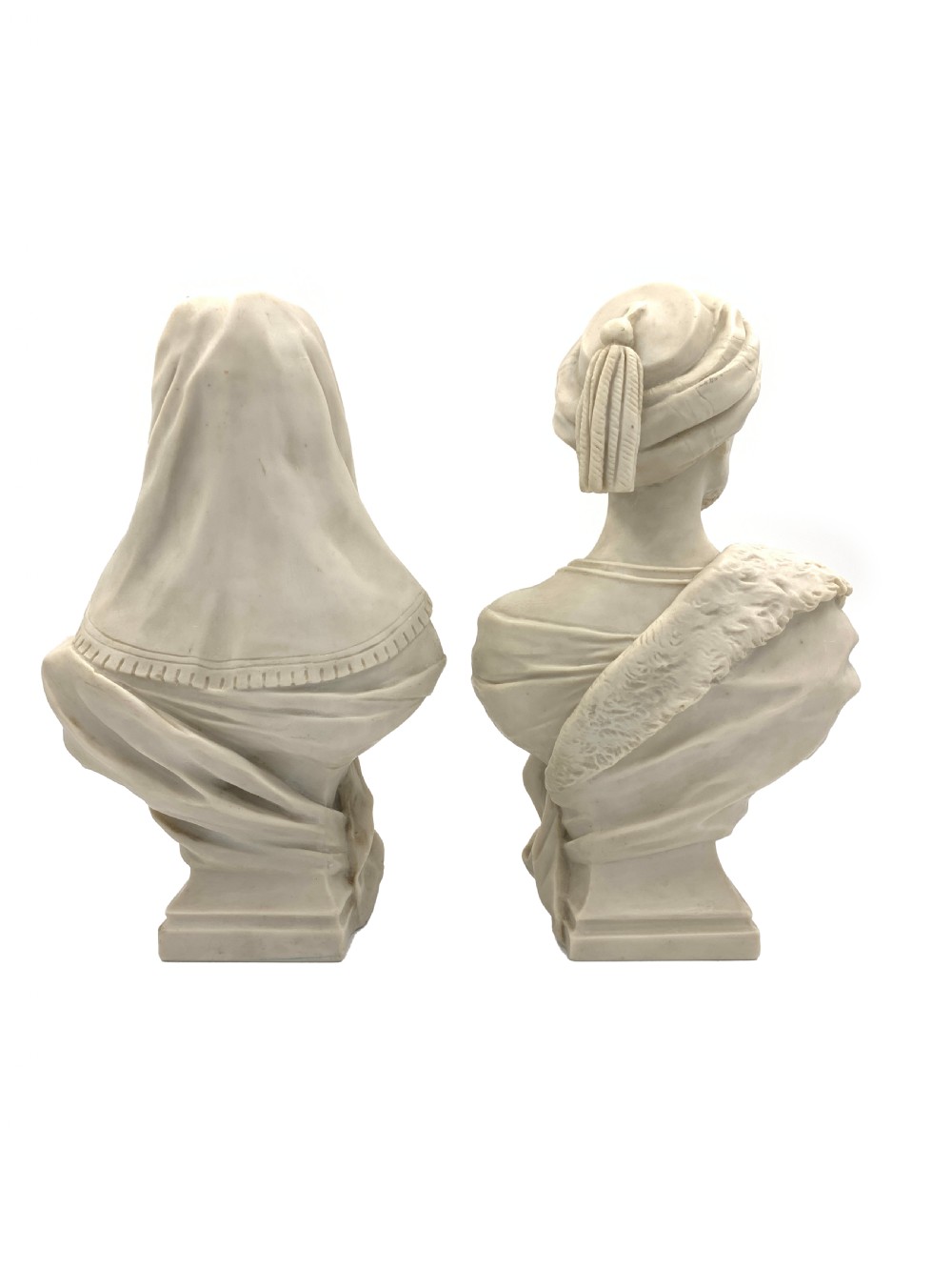 A pair of carved off-white marble busts depicting a man and woman in detailed Orientalist dress and headwear on integral square bases. View III