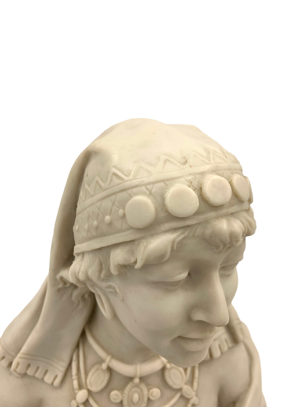 A pair of carved off-white marble busts depicting a man and woman in detailed Orientalist dress and headwear on integral square bases. View VI