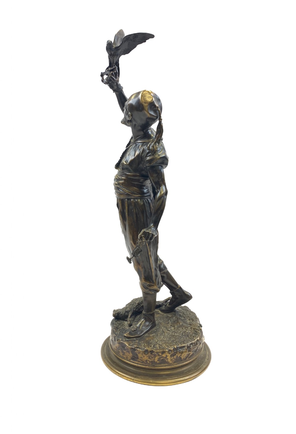 A dark brown patinated bronze sculpture depicting an Arab falconer holding a falcon overhead while standing on a circular base. View II