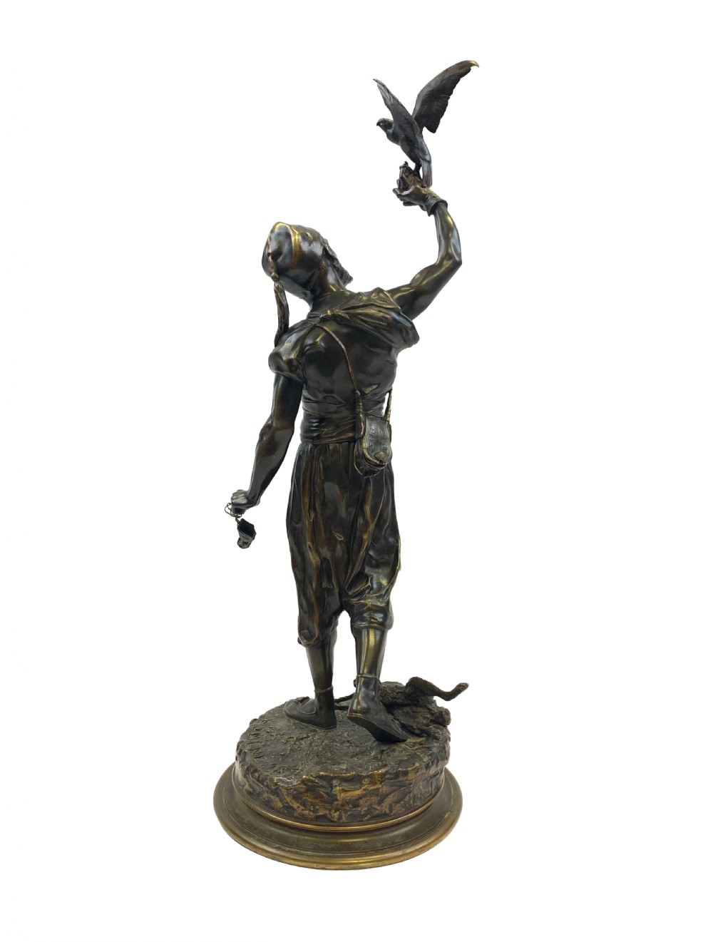 A dark brown patinated bronze sculpture depicting an Arab falconer holding a falcon overhead while standing on a circular base. View III